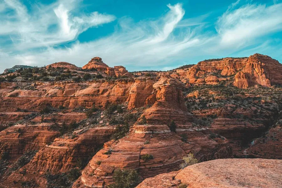 The red rock formations with green patches of grass In Red Rock State Park near Sedona, Arizona.