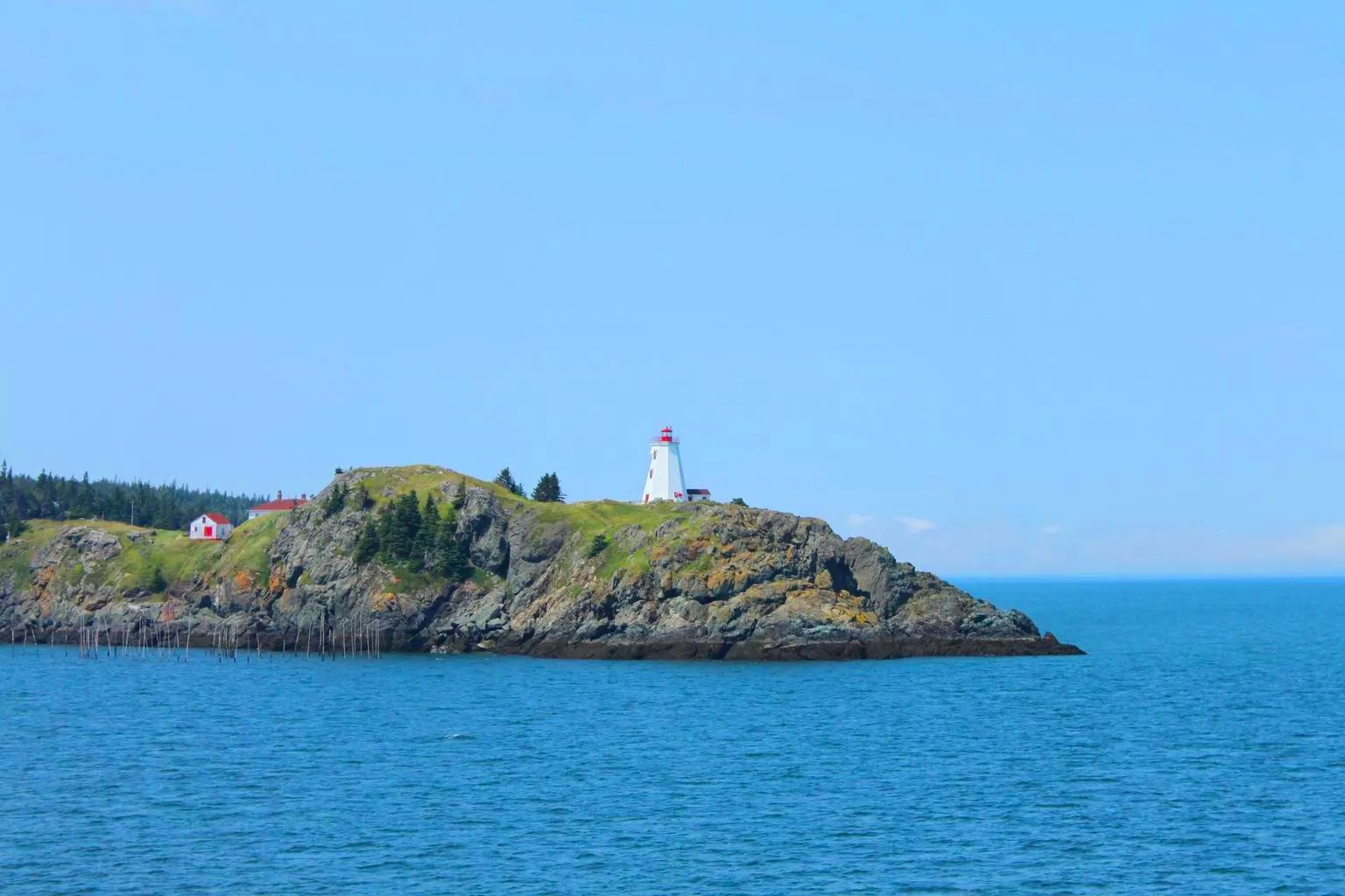 A view of the sea and the Swallowtail Lighthouse on Grand Manan Island, New Brunswick, Canada.