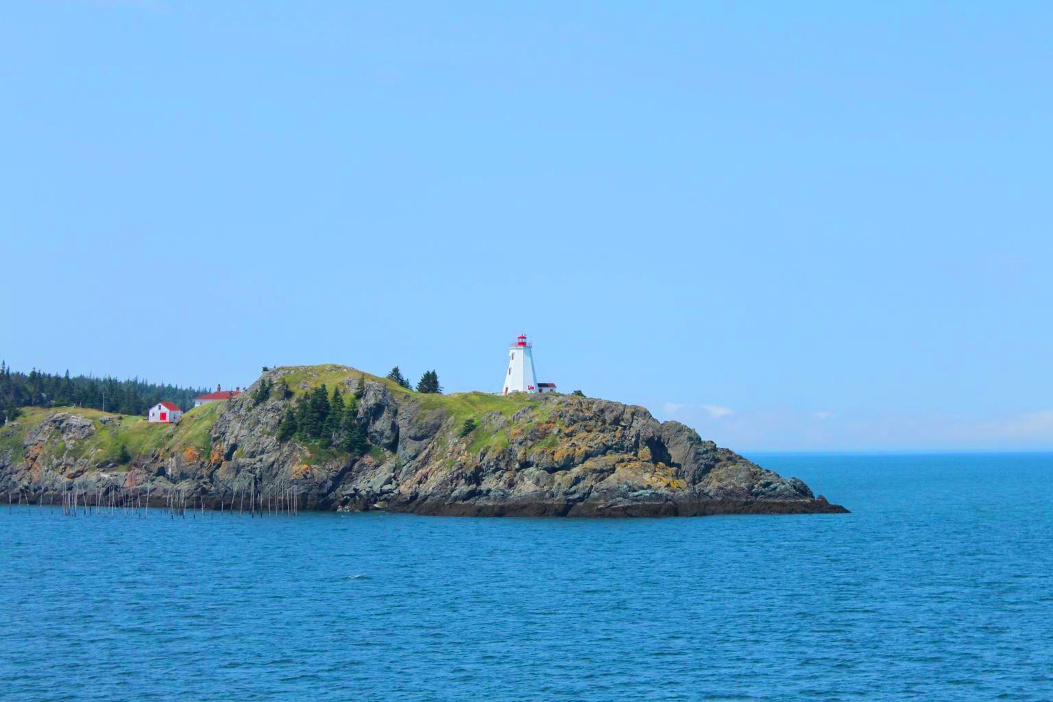 A view of the sea and the Swallowtail Lighthouse on Grand Manan Island, New Brunswick, Canada.